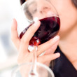 Low angle view of a businesswoman drinking red wine