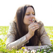 Beautiful young woman smelling flowers
