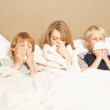 Mother and Sons Ill in Bed